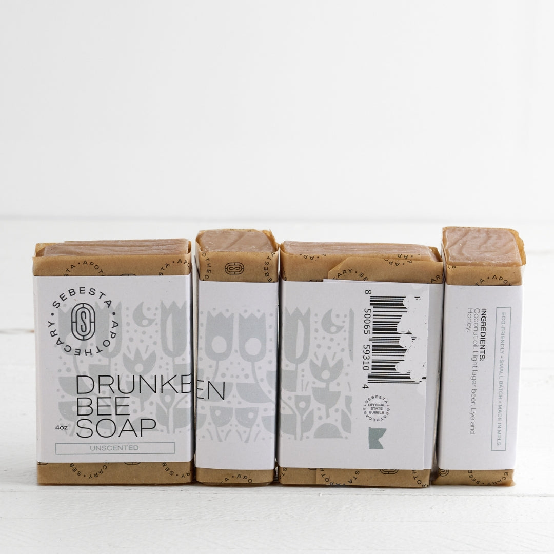 4 bars of Drunken Bee Soap with Sebesta Apothecary Branding on a white background