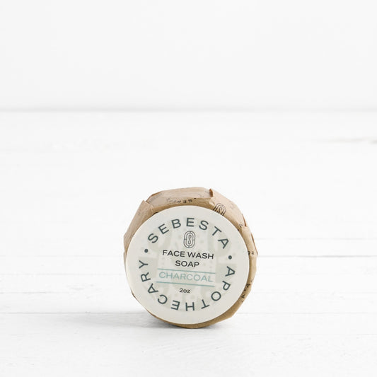 Front label of round Soap in wrapper with Sebesta Apothecary Branding on white background