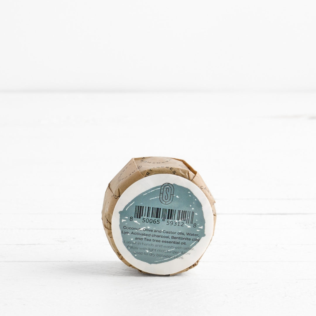 Back label of round Soap in wrapper with Sebesta Apothecary Branding on white background