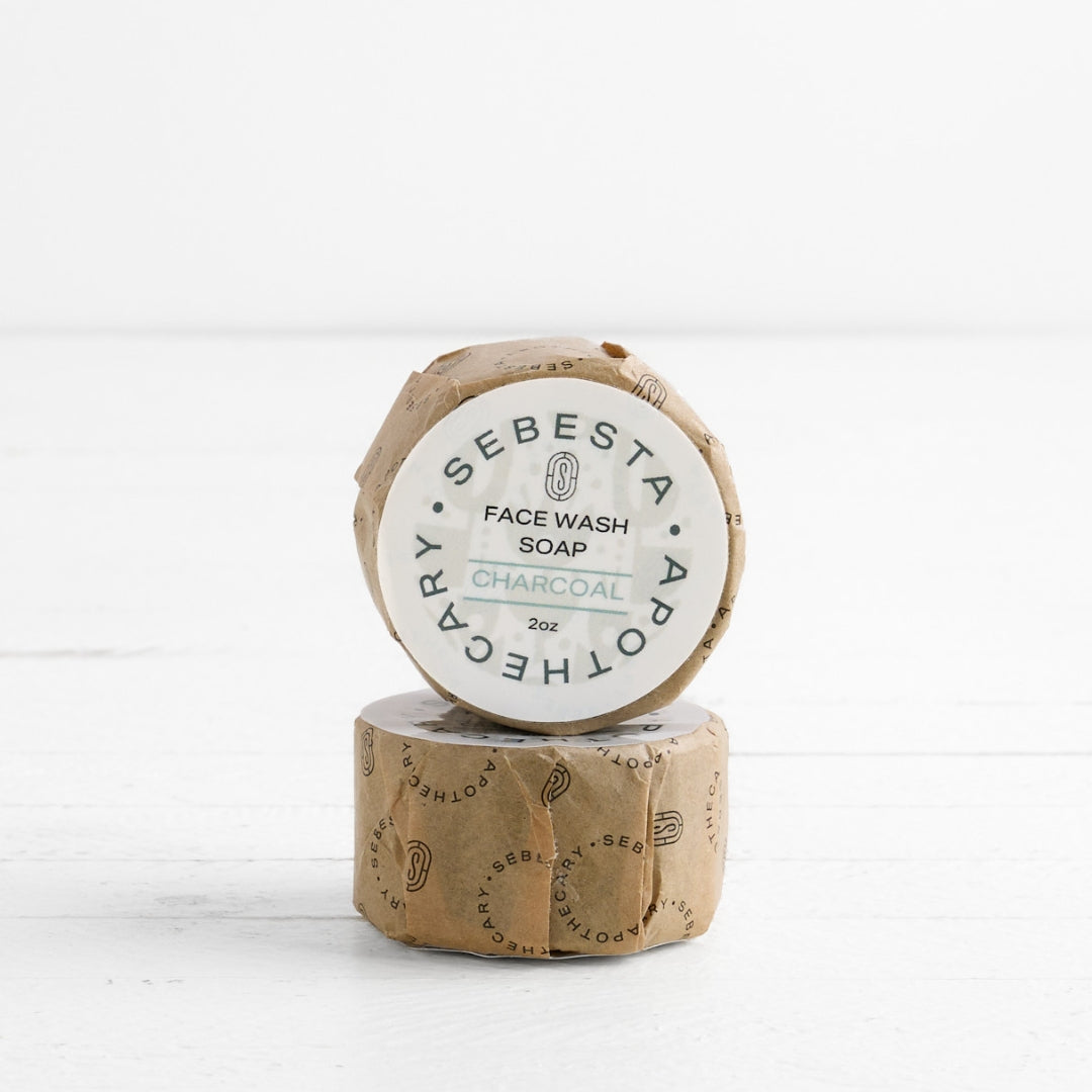2 round bars of soap stacked with Sebesta Apothecary Branding on white background