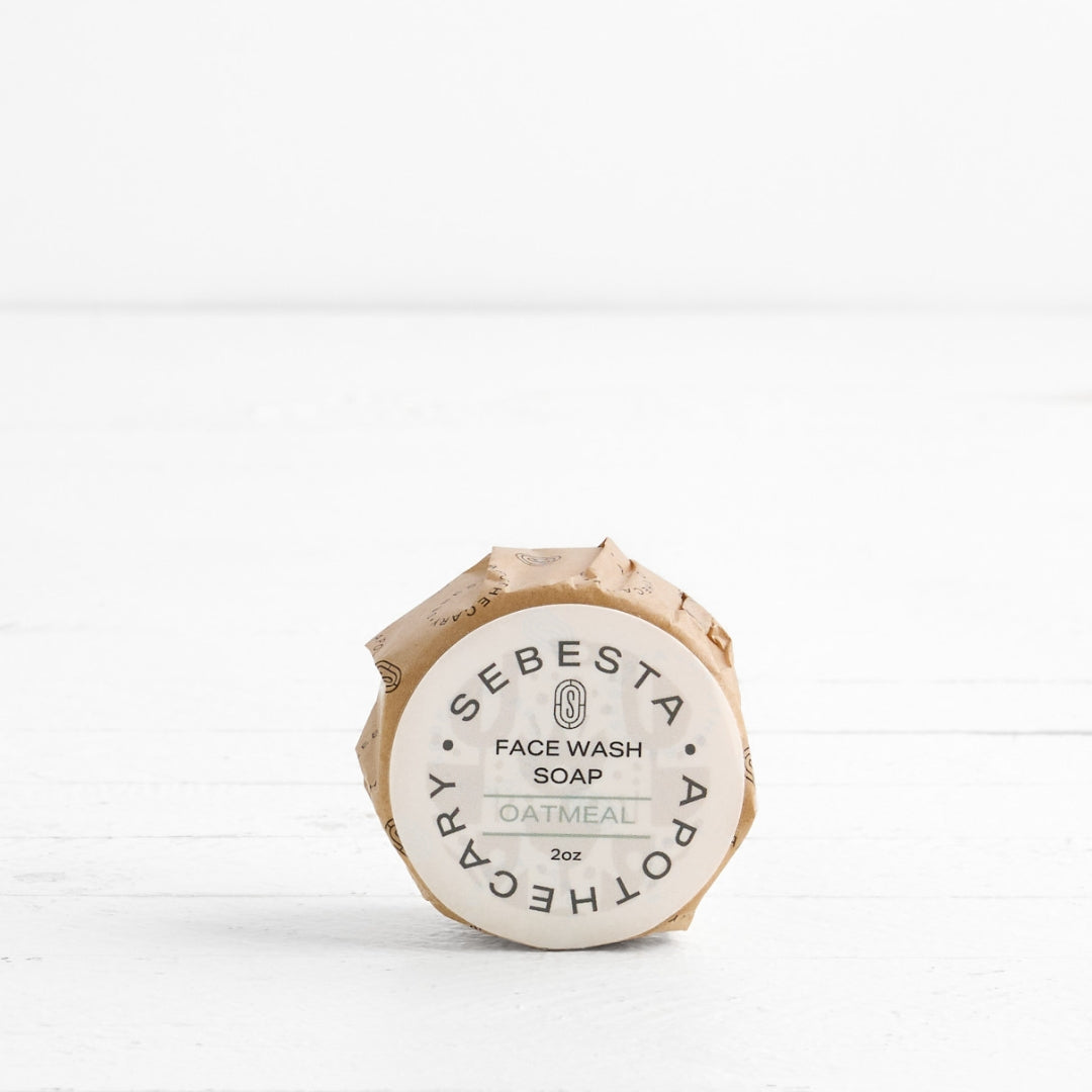 Front label of round Soap in wrapper with Sebesta Apothecary Branding on white background