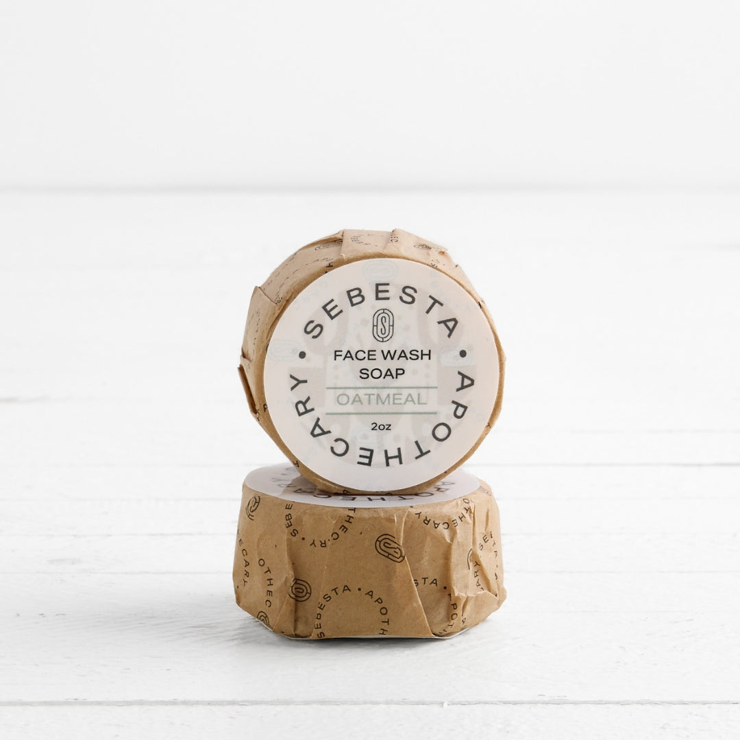2 round bars of soap stacked with Sebesta Apothecary Branding on white background