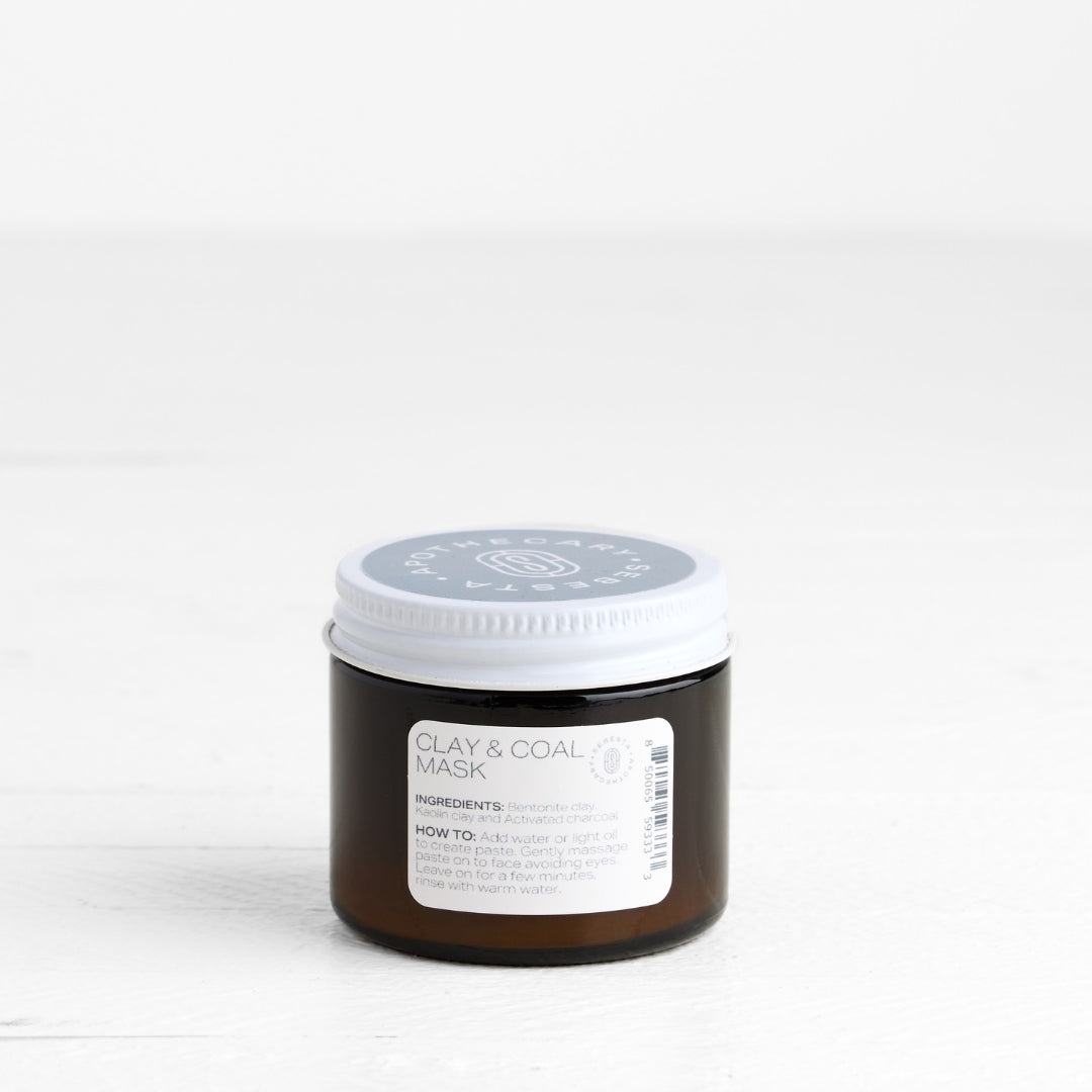Jar of clay and coal mask on a white background