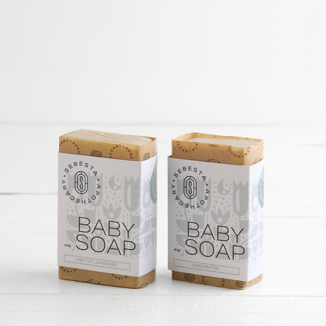 Two bars of Baby Soap Sebesta Apothecary Branding on a white background