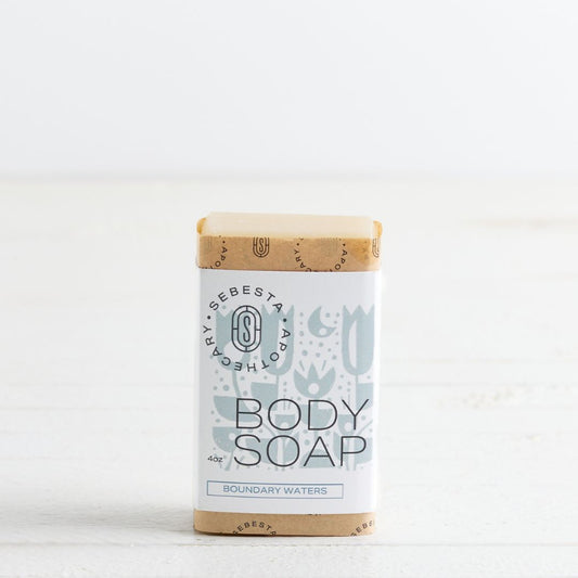 Sebesta Apothecary Soap bar - Single bar standing labeled Boundary Waters. White background and table