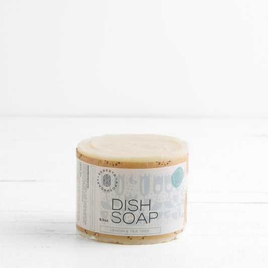 front of large cylinder bar of soap with Sebesta Apothecary Branding on white background