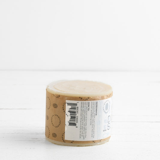 Side of large cylinder bar of soap with Sebesta Apothecary Branding on white background