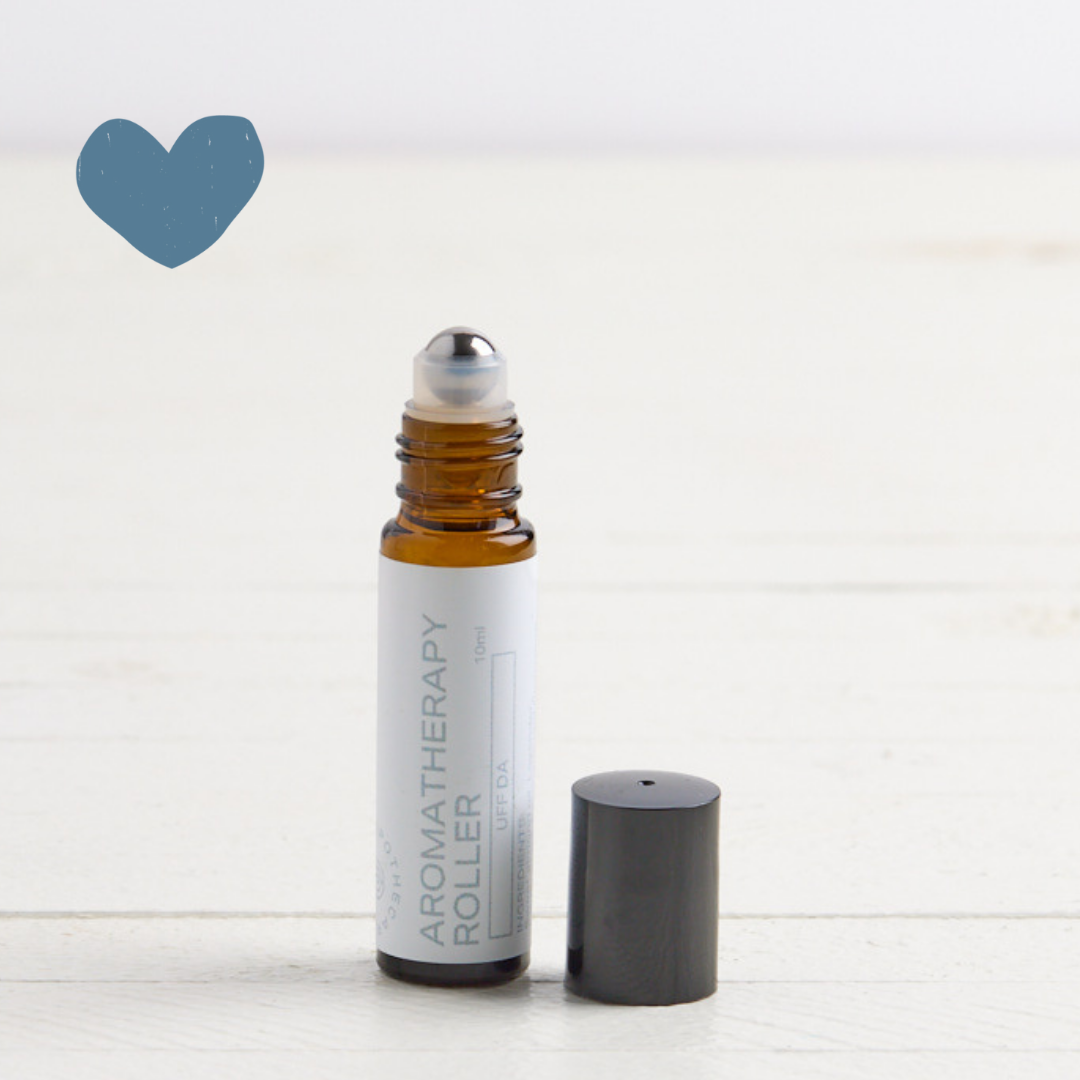 Sebesta Apothecary Aromatherapy Roller with cap off to side on white table with white background. Sent called Uff Da. Blue heart icon top left
