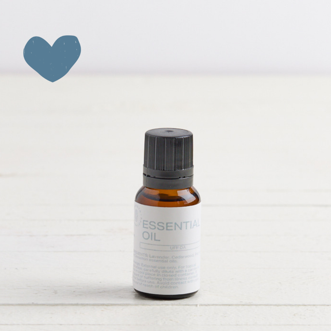 Sebesta Apothecary Essential oil single bottle on white table with white background. Sent called Uff Da. Blue heart icon top left