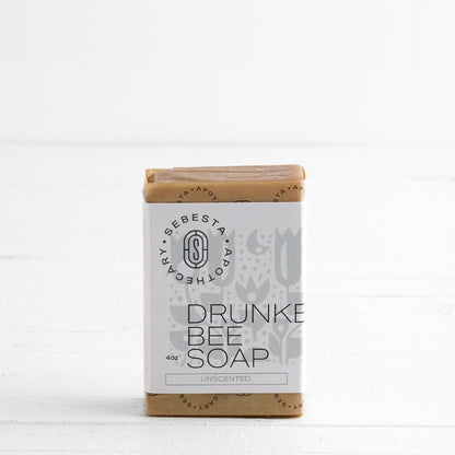 single bar of Drunken Bee Soap with Sebesta Apothecary Branding on a white background