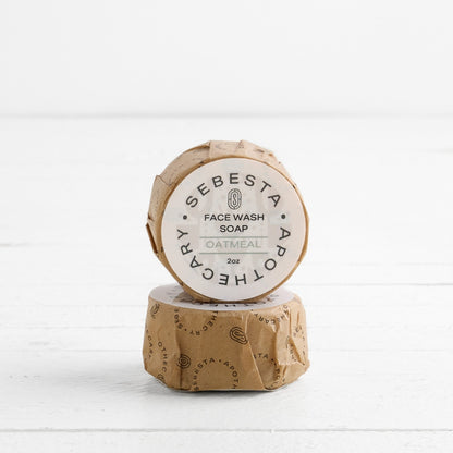 2 round bars of soap stacked with Sebesta Apothecary Branding on white background