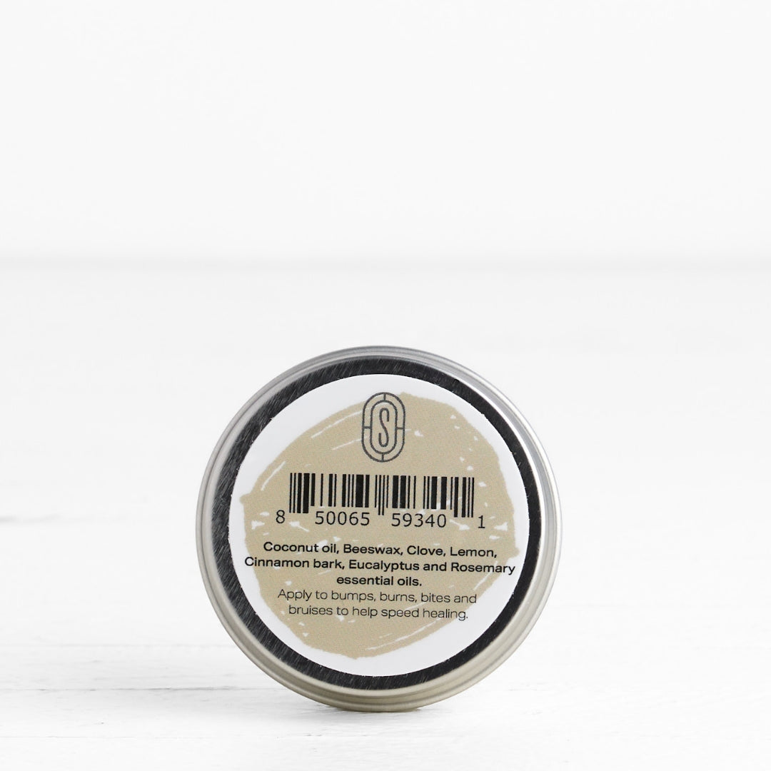 Back of small round container with a label on a white background