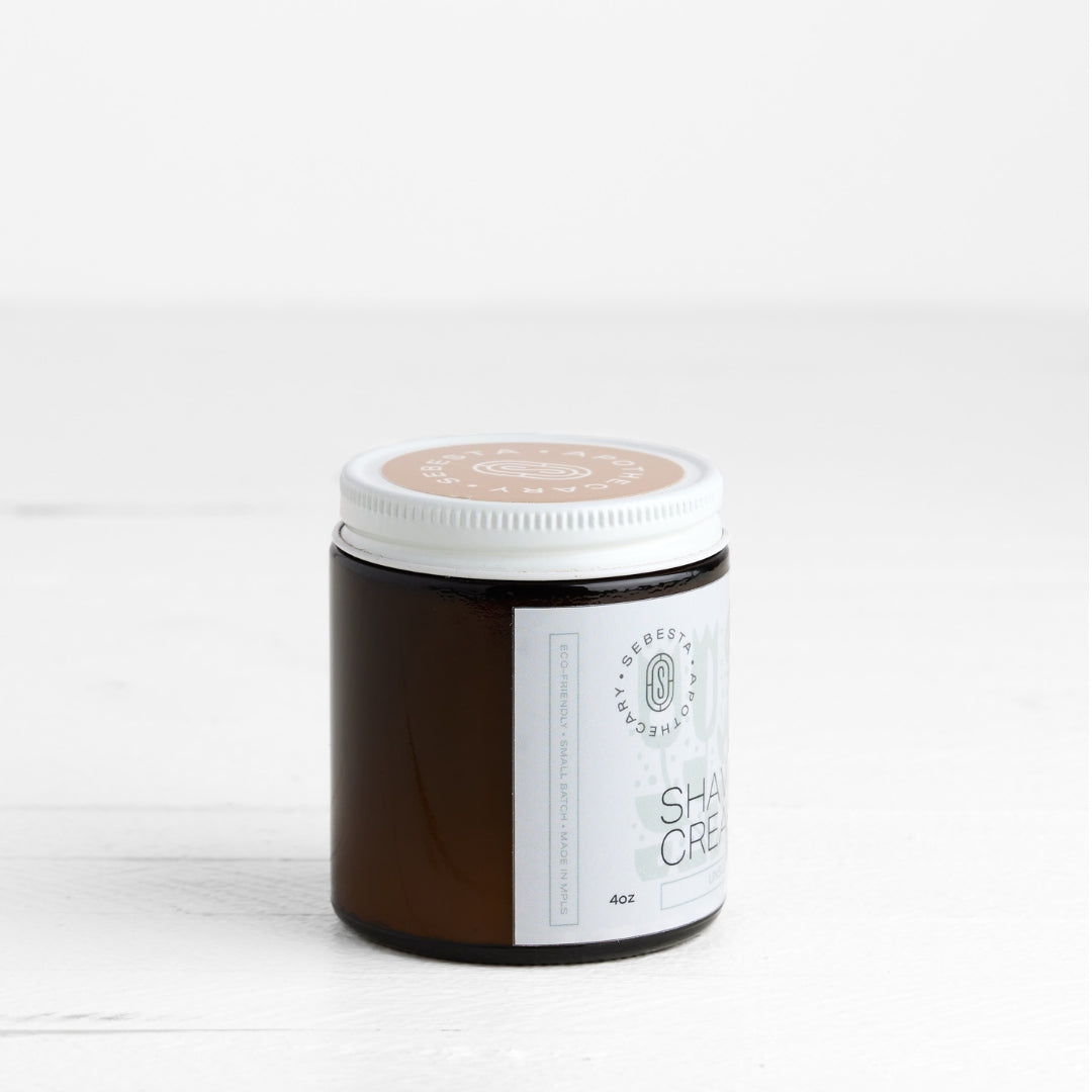 Jar of shaving cream with a white label on a light background